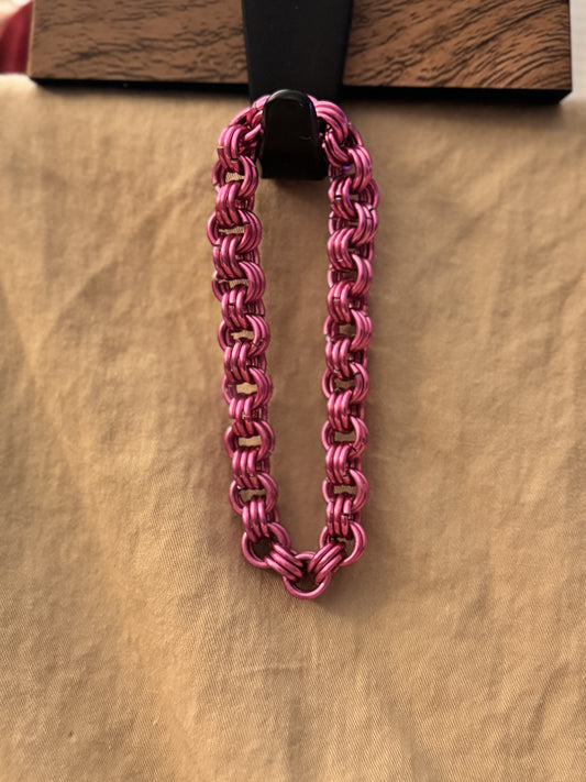 Pink chainmail bracelet.